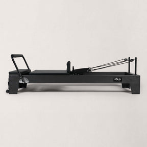 FOLD STUDIO Reformer machine with a sleek design in black, perfect for home or professional Pilates workouts.