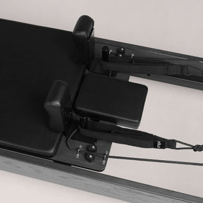 FOLD STUDIO Reformer close-up view of the padded surface and adjustable parts for precise exercise.