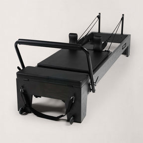 FOLD STUDIO Reformer machine in sleek black design with premium hardwoods and vegan-friendly upholstery.