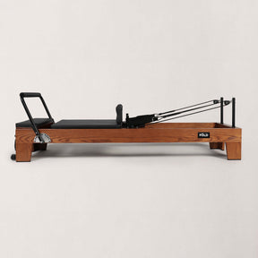 FOLD STUDIO Reformer machine in premium hardwoods with vegan upholstery for home and commercial use.