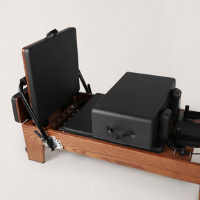 FOLD STUDIO Reformer close-up view showcasing premium hardwood and vegan upholstery details.