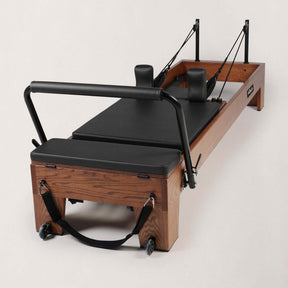 FOLD STUDIO Reformer machine designed for home and commercial use, featuring premium hardwoods and vegan-friendly upholstery.
