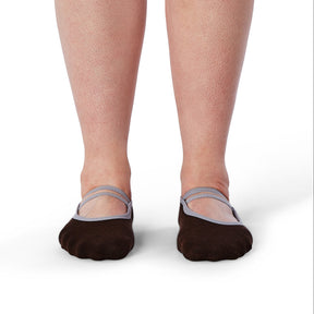 Brown socks with gray straps worn by a person on a white background