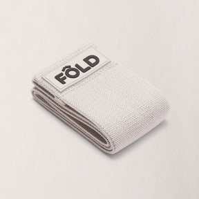 Pilates Resistance Band - Grey Medium, folded with FÔLD logo, designed for strength and comfort during workouts.