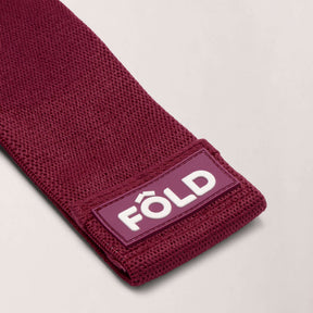 Pilates Resistance Band - Magenta Heavy close-up showing FÔLD logo and textured design for advanced workouts.