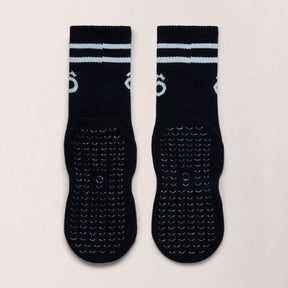 Crew Pilates Grip Socks and Resistance Band Bundle – Essentials in black with white sporty stripes and grip bottom.