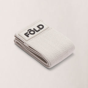 Pilates Resistance Band - Timber Wolf Medium, folded with FÔLD logo, designed for strength and comfort during workouts.