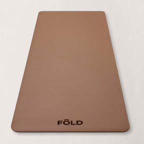 FOLD Yoga Mat - Caramel on a neutral background, designed for yoga, Pilates, and home workouts.