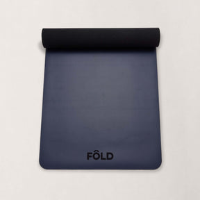 FOLD Yoga Mat - Navy, showcasing its non-slip surface, perfect for yoga and Pilates sessions.