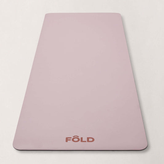 FOLD Yoga Mat - Pink, featuring a safe grip surface for yoga and Pilates workouts.