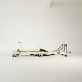 Pilates reformer machine on a white background