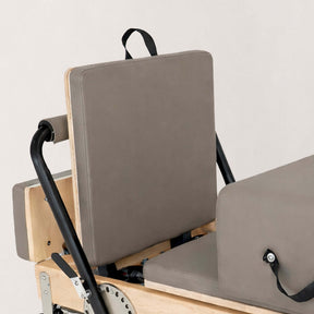 FÔLD Jumpboard on a FÔLD Reformer with Mocha upholstery