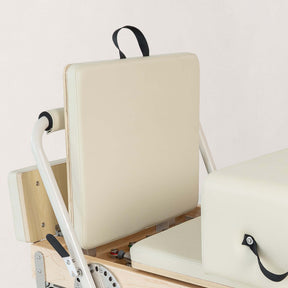 FÔLD Jumpboard on a FÔLD Reformer with Vanilla upholstery