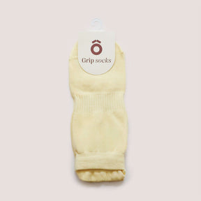 Pilates Low Rise Grip Socks - Butter Yellow displayed with a tag showcasing Grip Socks branding.