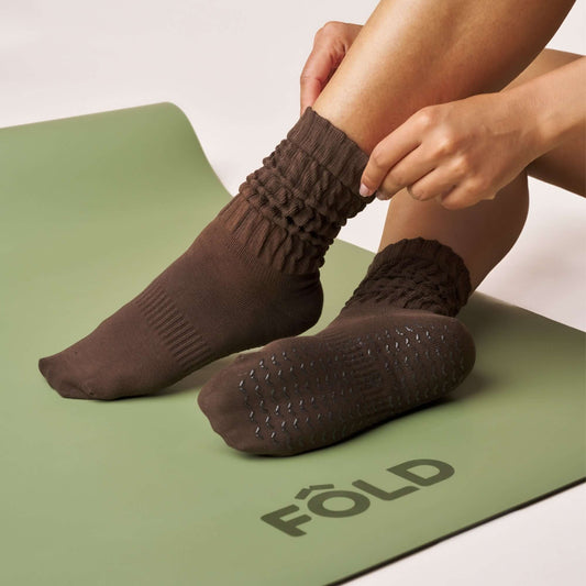 Scrunch Grip Socks - Cocoa worn on a yoga mat, featuring a scrunch design and non-slip soles for grip.