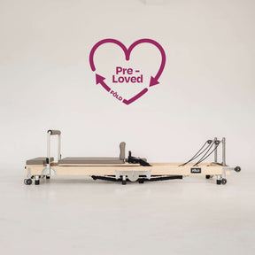 Pre-Loved Original FOLD Reformer - With Easi-Fold™ (Copy) in a bright studio setting with heart graphic.