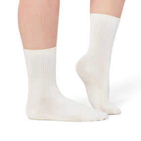 White socks worn by a person on a white background