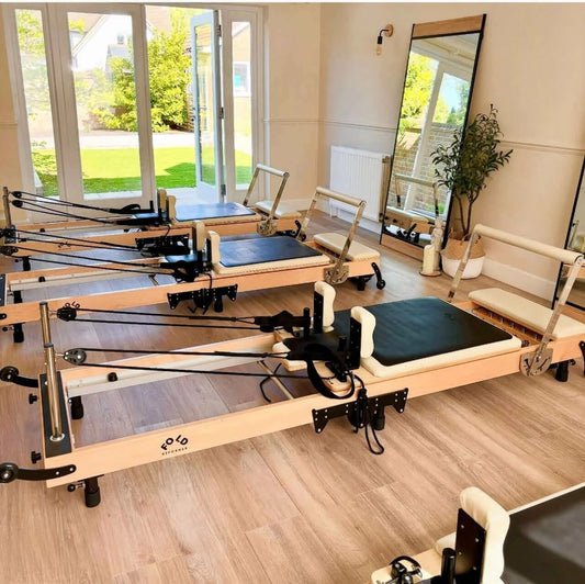 Get Ready for January: Your Studio and Gym Launch Checklist - Pilates reformers in a bright studio.