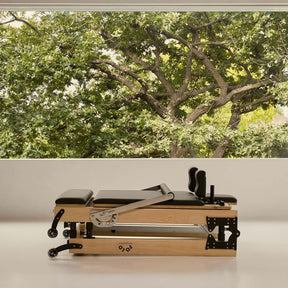 Folded FOLD Reformer bed in black with trees & leaves in background window