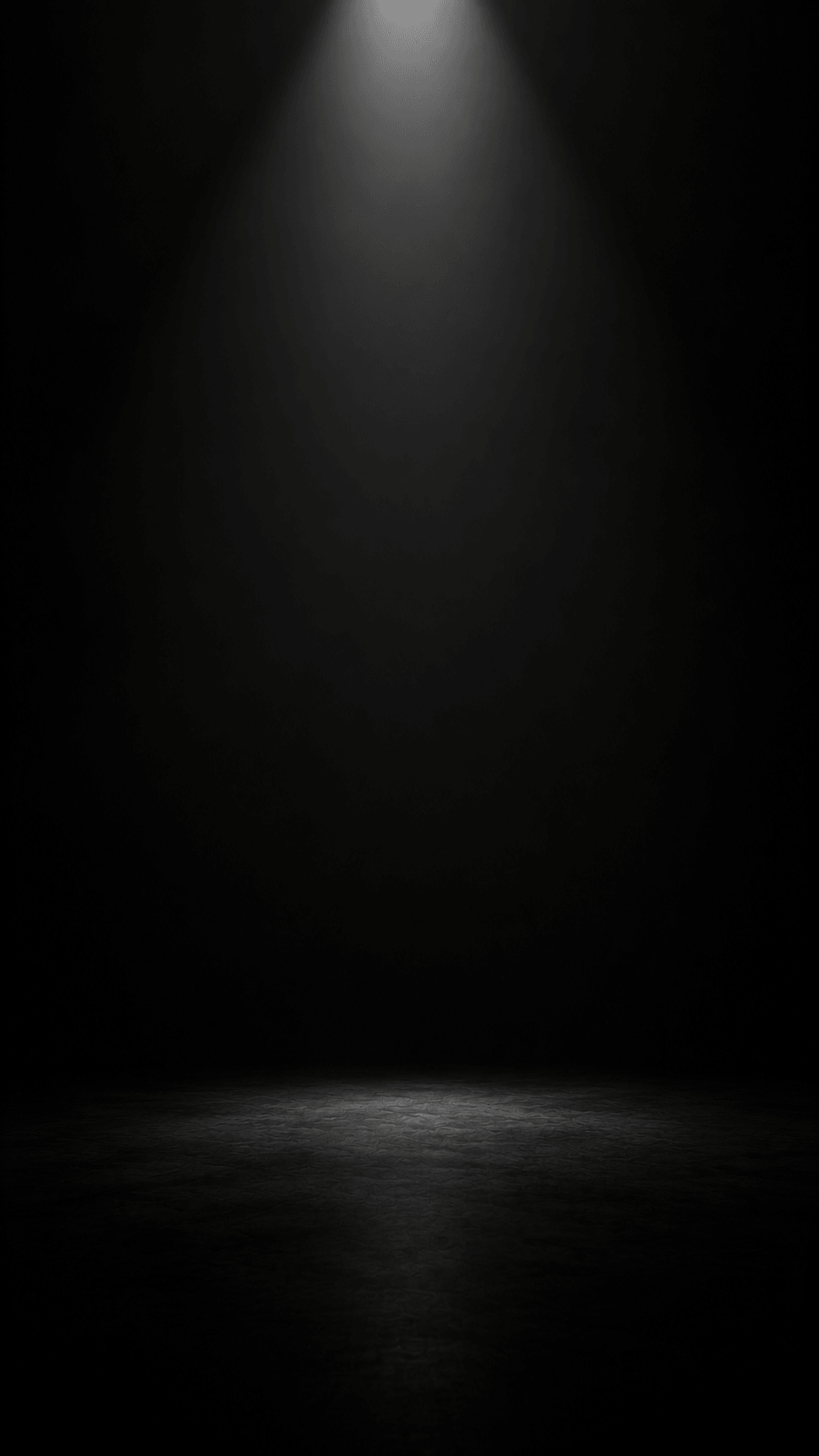 Dimly lit spotlight on a dark stage, creating a dramatic and mysterious ambiance, perfect for performances.