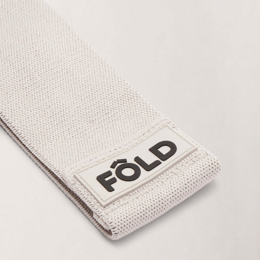 Pilates Resistance Band - Grey Medium showing close-up of FÔLD logo and texture detail.