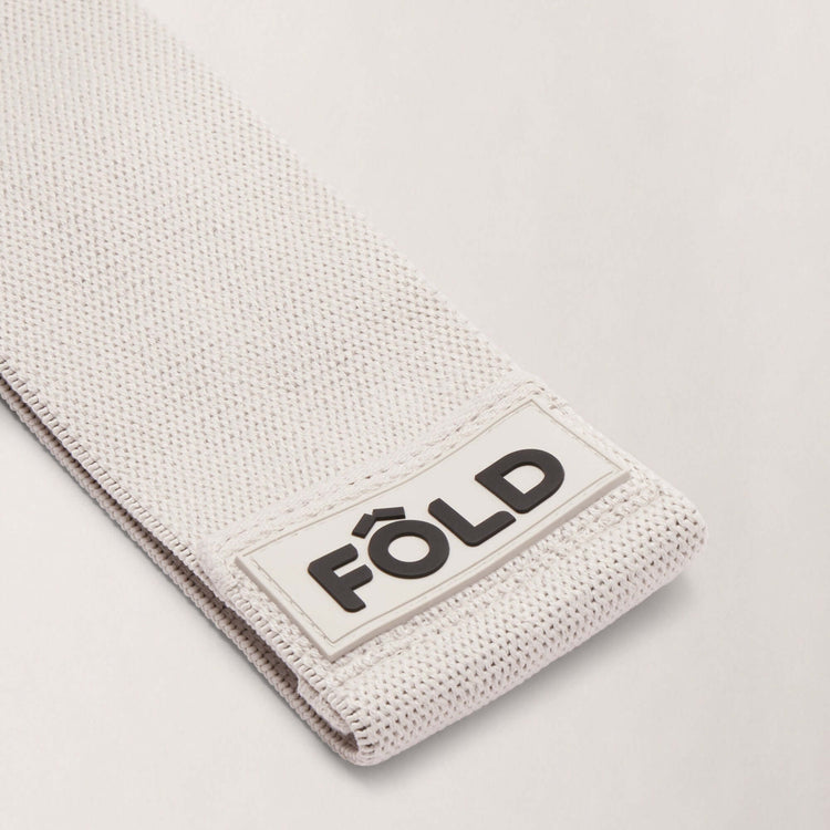 Pilates Resistance Band - Grey Medium showing close-up of FÔLD logo and texture detail.