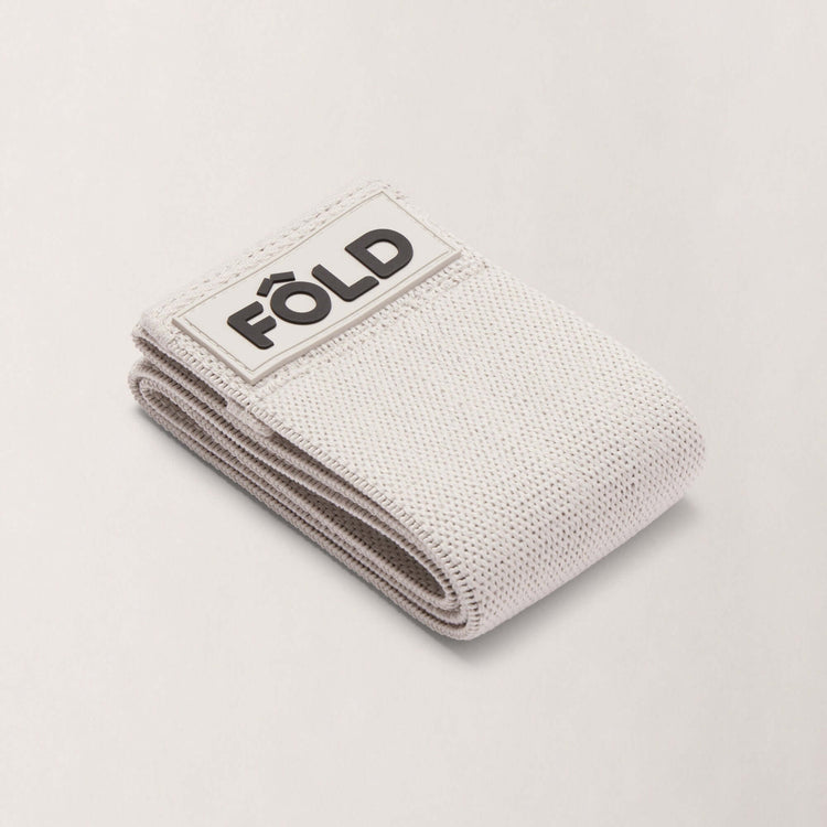 Pilates Resistance Band - Grey Medium, folded with FÔLD logo, designed for strength and comfort during workouts.