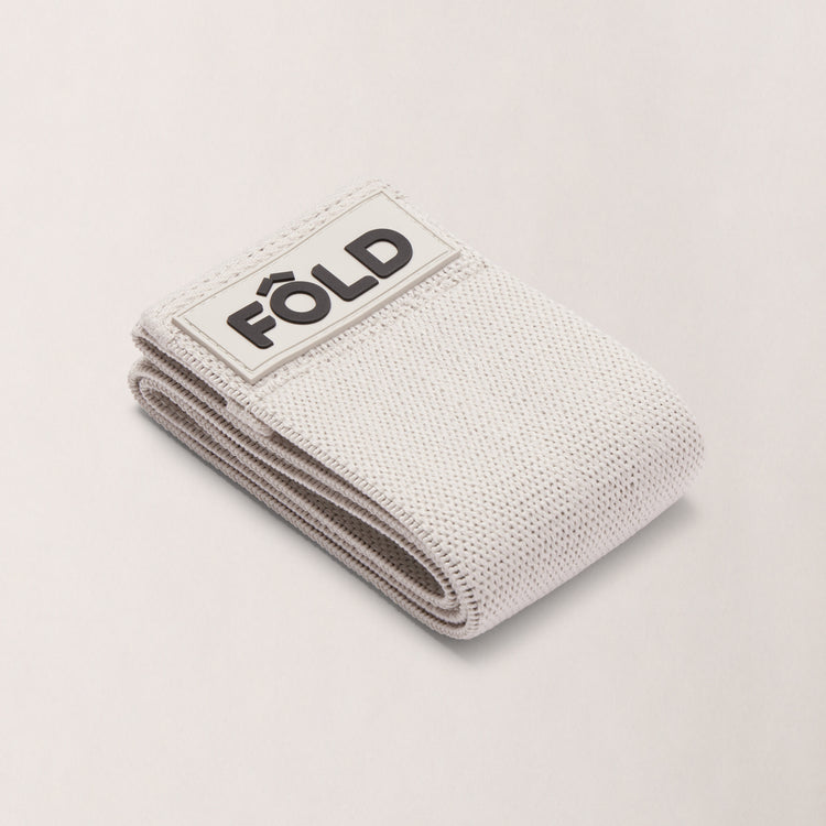 Pilates Resistance Band - Timber Wolf Medium, folded with FÔLD logo, designed for strength and comfort during workouts.