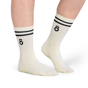 White socks with black stripes and a logo on a white background