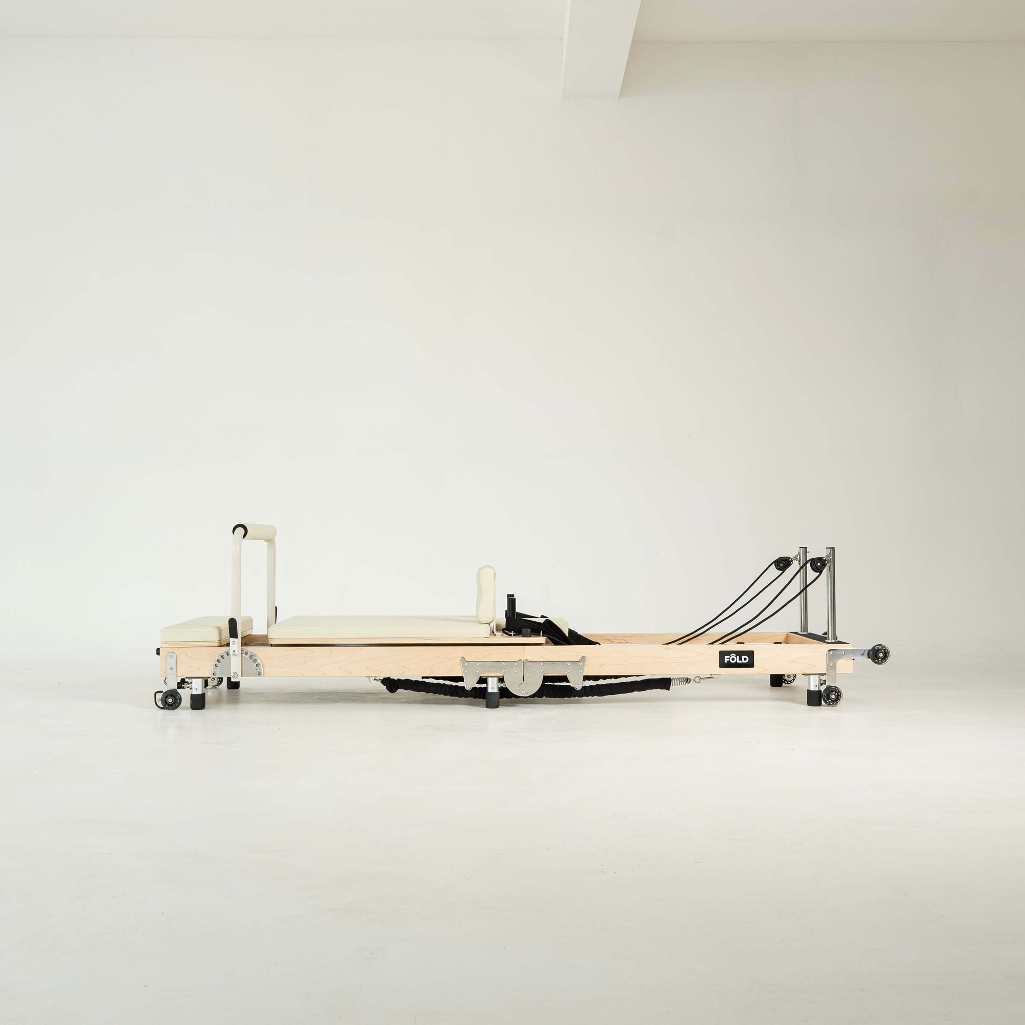 Pilates reformer machine on a white background