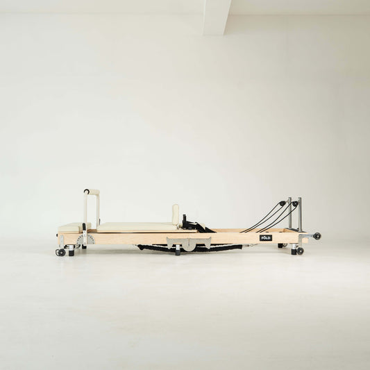 Pilates reformer machine on a white background