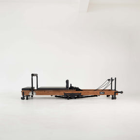 Wooden Pilates reformer on a white background