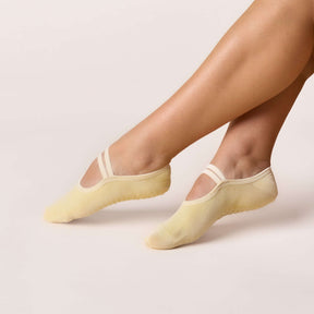 Ballet Grip Socks - Butter Yellow shown on feet for barre, yoga, and Pilates with a non-slip grip sole.