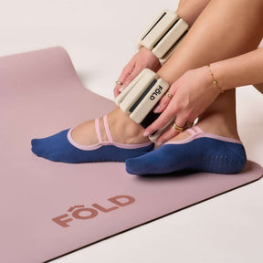 Ballet Grip Socks - Estate Blue & Pink on yoga mat with ankle weights, showcasing no-slip grip and soft elastic strap.
