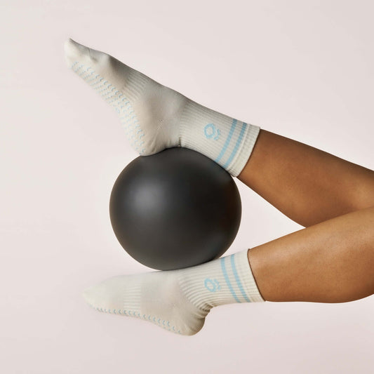 Everyday Crew Grip Socks - Baby Blue worn on feet balancing on a black exercise ball.