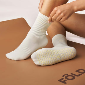 Everyday Crew Grip Socks - Butter Yellow worn on a Pilates mat, featuring non-slip soles and breathable knit design.
