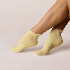 Pilates Low Rise Grip Socks - Butter Yellow, showcasing soft, breathable fabric and secure low-rise design for comfort.