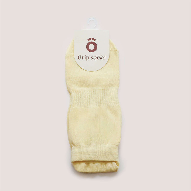 Pilates Low Rise Grip Socks - Butter Yellow displayed with a tag showcasing Grip Socks branding.