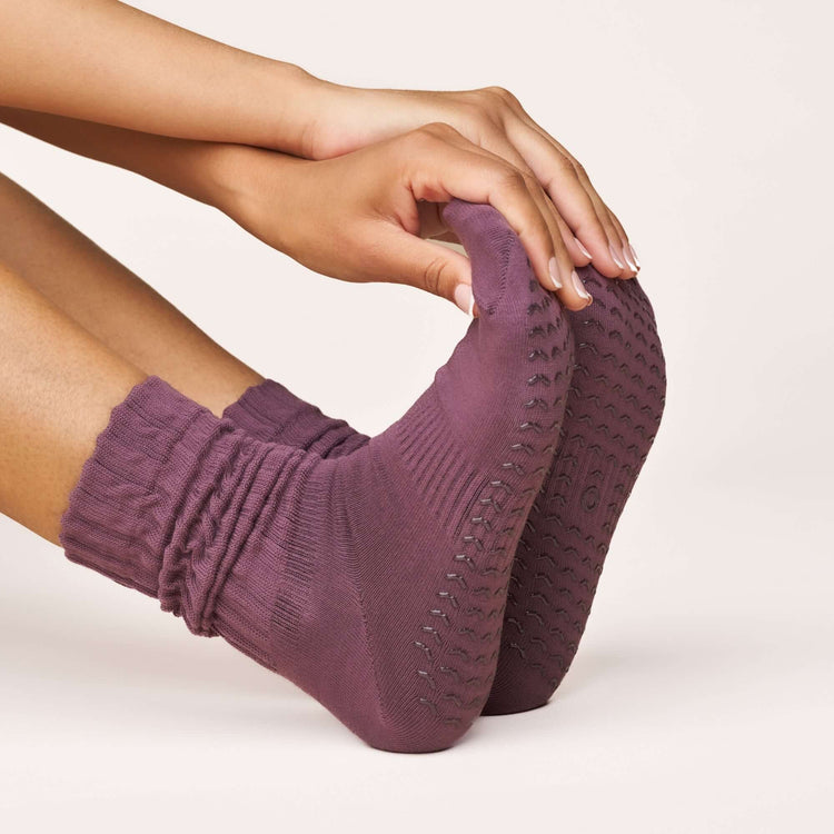 Woman wearing Pilates Scrunch Grip Socks - Magenta, showcasing the non-slip grip and soft cotton design.